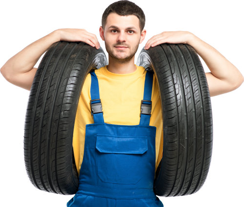 tire-service-worker-in-blue-uniform-holds-car-P5JZUQ6